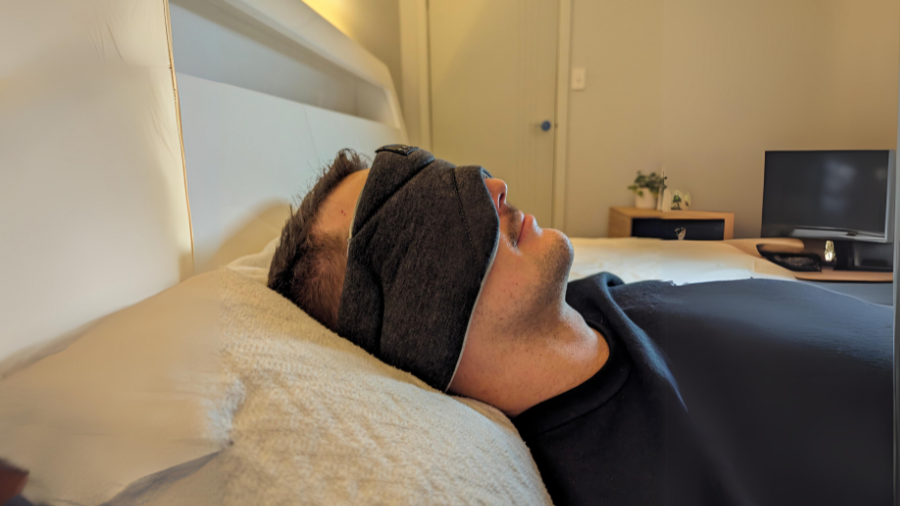 man suffering from tinnitus uses sleep headphones to help them sleep